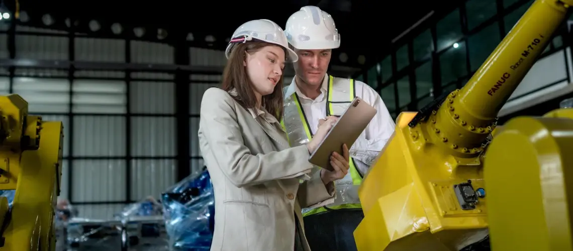 Valuer assessing industrial equipment in a Victorian warehouse