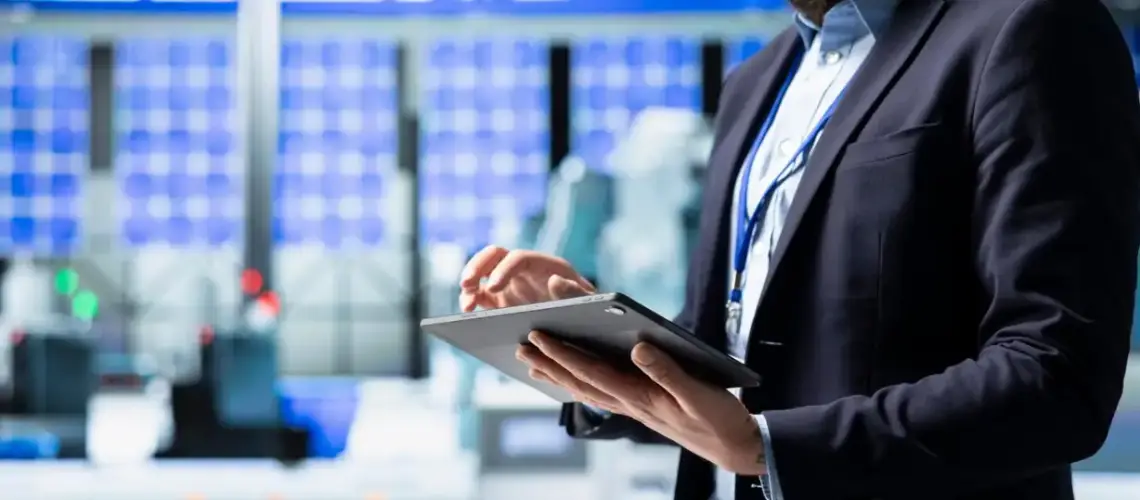 Valuer conducting an industrial business valuation in a factory setting